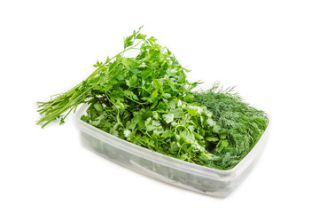 Plastic tray with coriander and dill and bunch of parsley