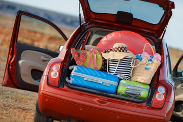 Suitcases and bags in trunk of car ready to depart for holidays