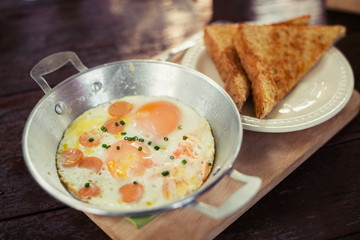 egg dish Breakfast served with fried egg, ham delicious.