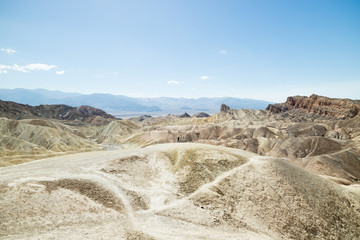 Man overlooking dry and arid sand dune landscape in Death Valley National Park