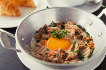 egg dish Breakfast served with fried egg, ham delicious.