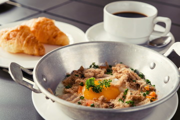 egg dish Breakfast served with fried egg, ham delicious.