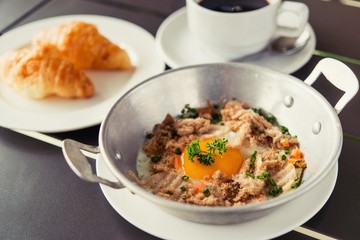 egg dish Breakfast served with fried egg, ham delicious.