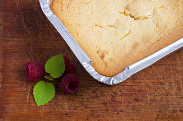 cake with raspberries and cream cheese decorated with fresh rasp