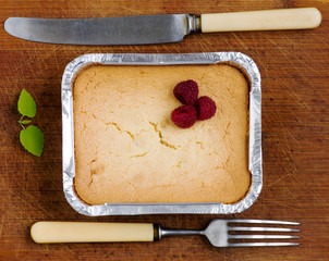 cake with raspberries and cream cheese decorated with fresh rasp