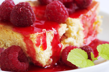 cake with raspberries and cream cheese decorated with fresh rasp