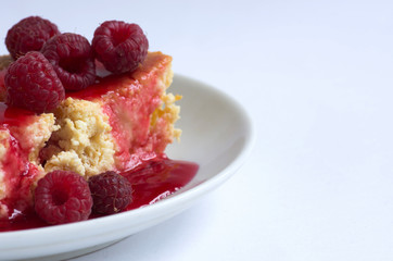 cake with raspberries and cream cheese decorated with fresh rasp