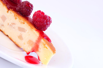 cake with raspberries and cream cheese decorated with fresh rasp
