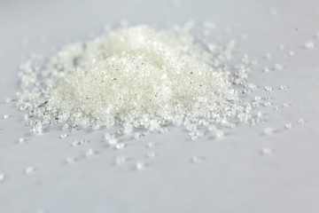 Closeup of white granulated sugar on Isolated White Background