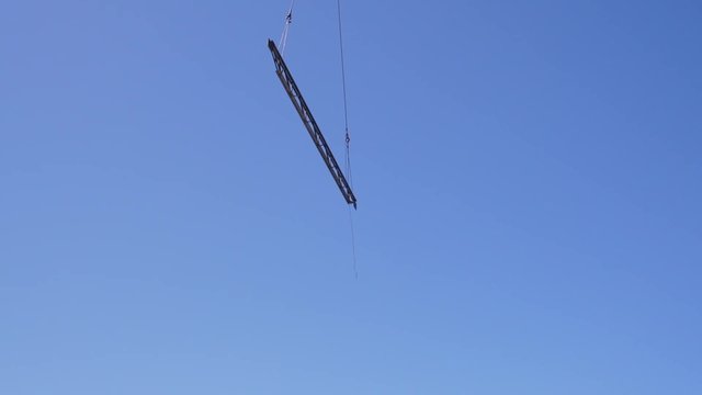 Steel Beam Dangles in the Sky