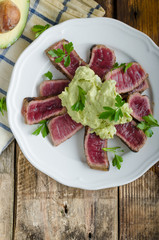 Beef steak with avocado dip and herbs
