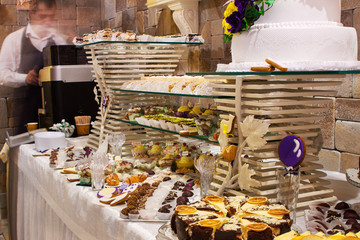 waiter and sweet desserts furshet table