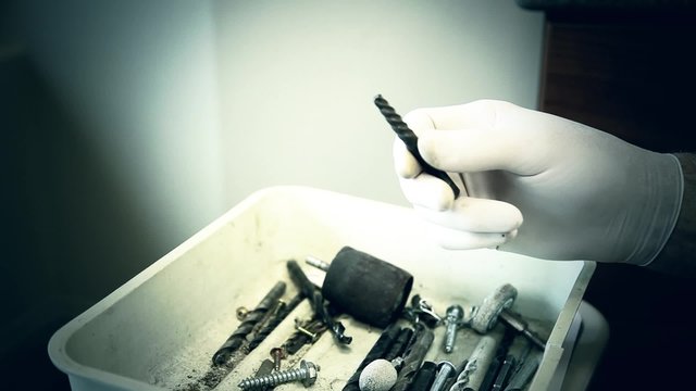 Evil Dentist Sorting Through Drill Bits