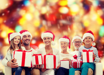 happy family in santa helper hats with gift boxes