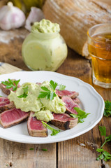 Beef steak with avocado dip and herbs