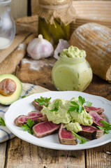 Beef steak with avocado dip and herbs