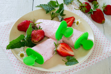 Fruit ice-cream in a bowl on a wooden table