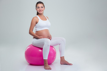 Pregnant woman sitting on a fitness ball