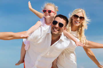 happy family having fun over blue sky background