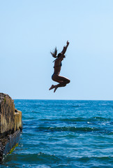 The girl jumping in the sea