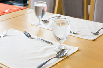 Glass of water on table setting for dining