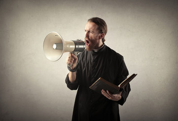 Priest shouting into a megaphone
