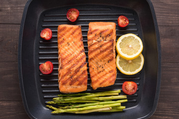 Grilled salmon cooked BBQ on a pan on wooden background