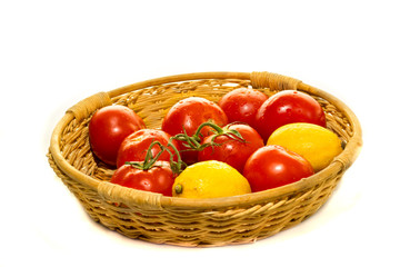 Garden tomatoes basket on white background