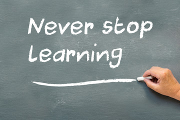 hand writing on a chalkboard Never stop learning