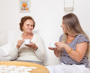 Carer having a cup of tea with an elderly woman