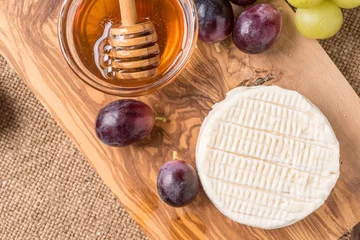 Foto op Plexiglas wooden board with cheese, grapes,and honey © stefanocar_75
