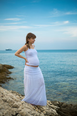 Fototapeta na wymiar Young Pregnant woman on the beach 