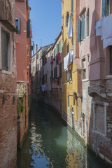 Fototapeta na wymiar The colorful houses in tight canal , Venice. Italy 