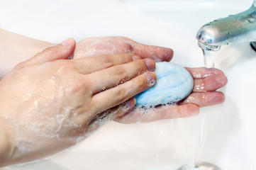 Fototapeta premium Washing of hands with soap under running water