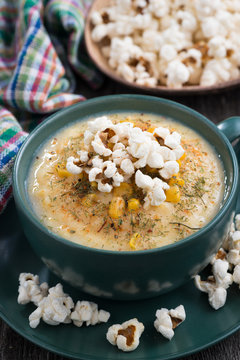 corn soup with popcorn, closeup, vertical