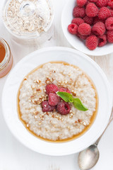 oatmeal with raspberries and honey, top view, vertical
