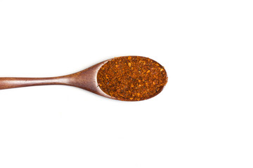 Red pepper in spoon on white background.