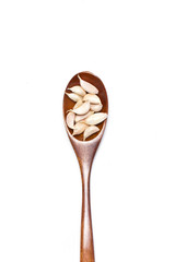 Garlic with wooden spoon isolated on white background.