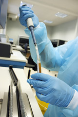 Hand with test tube of blood and pipe