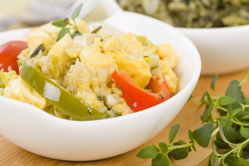 Ackee & Saltfish - Traditional Jamaican dish made of salt cod and ackee fruit. Served with callaloo.

