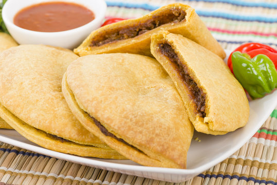 Caribbean Jerk Beef Patty - Jamaican Spicy Minced Jerk Beef With Onions And Peppers In Short Crust Pastry Served With Spicy Sauce And Scotch Bonnet Chillies.
