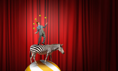 Businessman juggling with balls