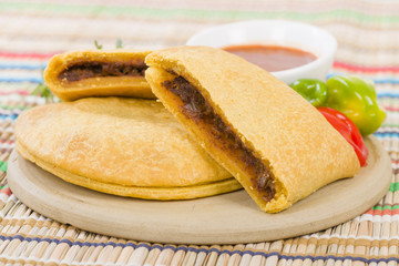 Caribbean Jerk Beef Patty - Jamaican spicy minced jerk beef with onions and peppers in short crust pastry served with spicy sauce and scotch bonnet chillies.
