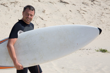 Man, with a surf on summer holidays