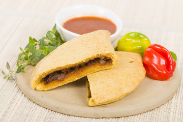 Caribbean Jerk Beef Patty - Jamaican spicy minced jerk beef with onions and peppers in short crust pastry served with spicy sauce and scotch bonnet chillies.
