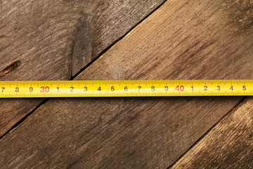 Measuring Tape on wood background.