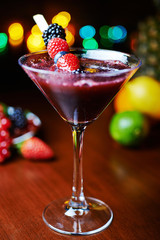 glass of tasty tropical cocktail with berries or lemonade.