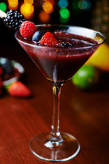 glass of tasty tropical cocktail with berries or lemonade.