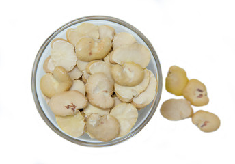 Dried beans in bowl on white background seen from above