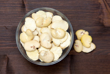 Dried beans in bowl on wooden table top views